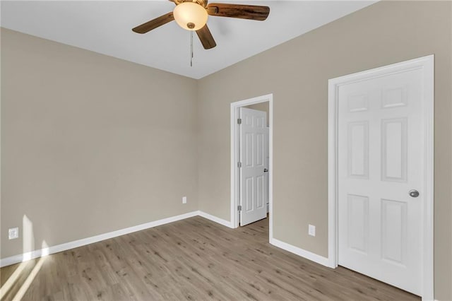 unfurnished bedroom featuring light wood-type flooring and ceiling fan