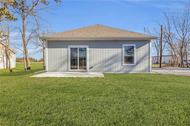 rear view of house with a lawn and a patio