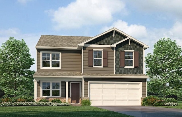 view of front of home featuring a garage and a front yard