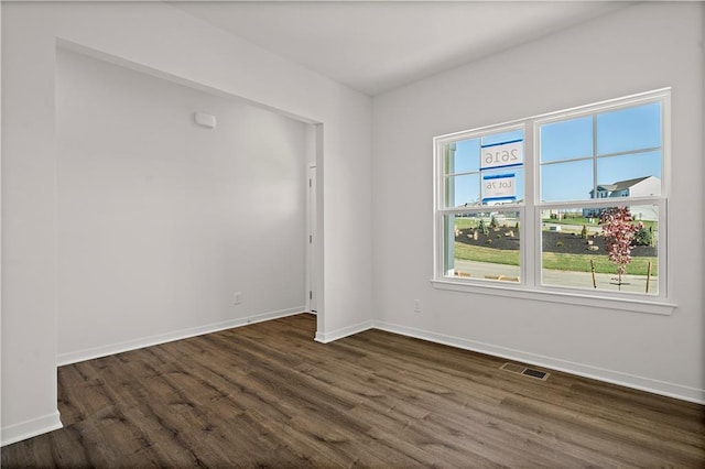 spare room with dark wood-type flooring