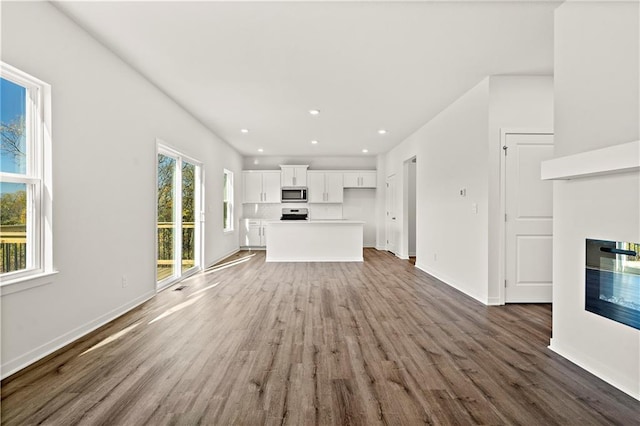 unfurnished living room featuring dark hardwood / wood-style flooring