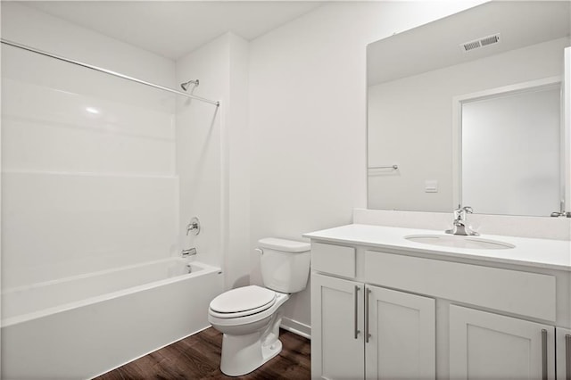 full bathroom featuring wood-type flooring, toilet, vanity, and  shower combination