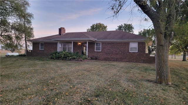 single story home featuring a yard