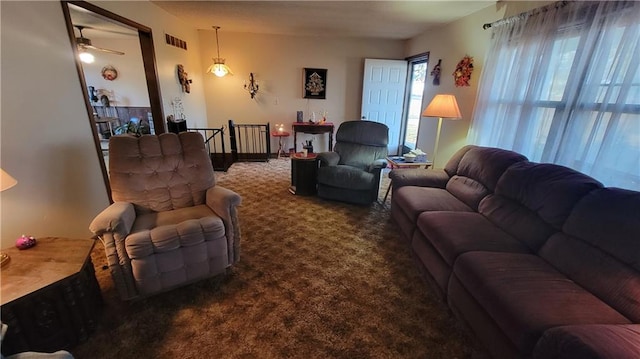 living room featuring carpet floors and ceiling fan