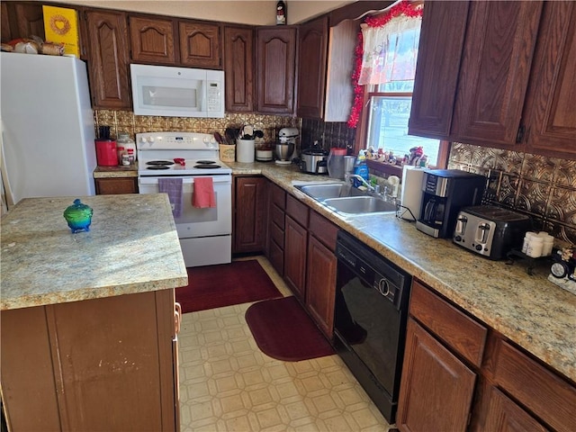 kitchen featuring decorative backsplash, sink, and white appliances