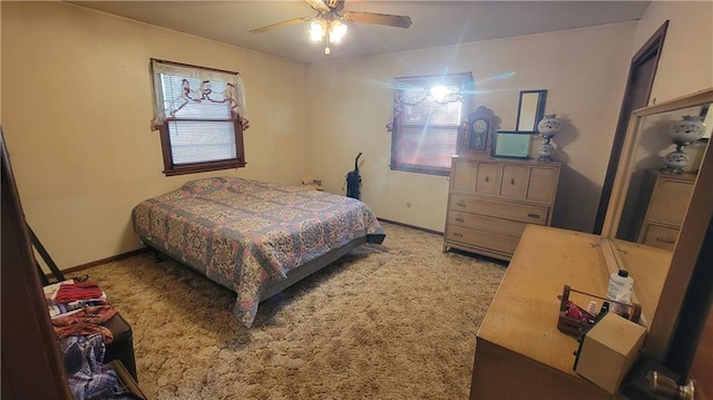 carpeted bedroom with ceiling fan and multiple windows