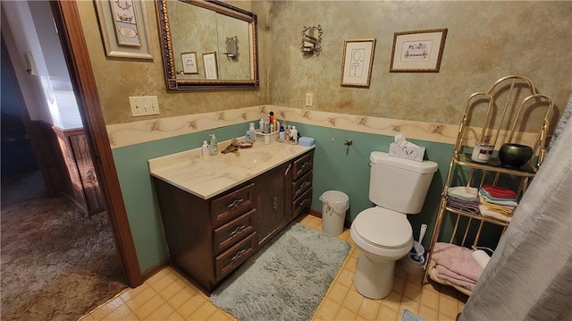 bathroom with toilet and vanity