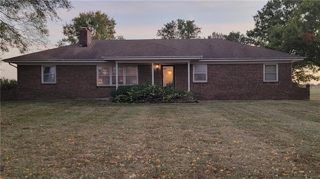 back house at dusk with a yard