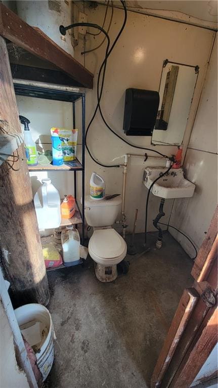 bathroom featuring toilet and concrete floors