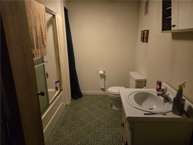 full bathroom featuring enclosed tub / shower combo, vanity, and toilet