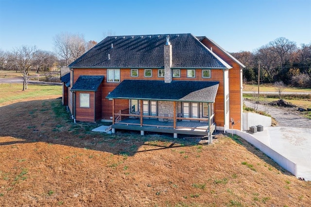20473 199th St, Tonganoxie, KS 66086 - back of house with covered porch and roof with shingles
