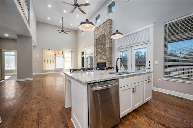 20473 199th St, Tonganoxie, KS 66086 - kitchen with dishwasher, open floor plan, ceiling fan, a sink, and a towering ceiling