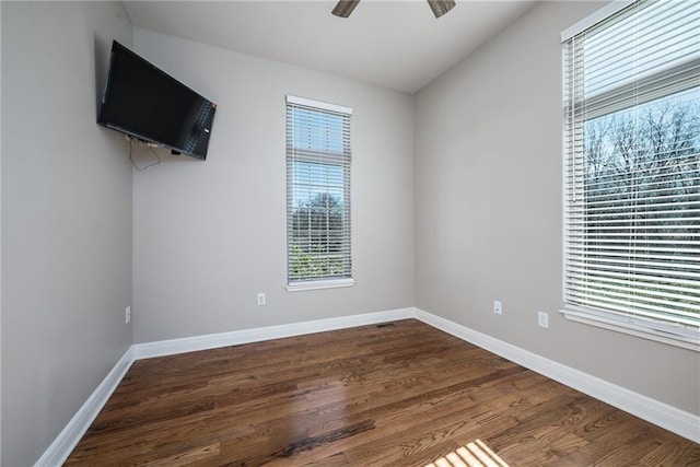 20473 199th St, Tonganoxie, KS 66086 - unfurnished room with plenty of natural light, dark wood-type flooring, ceiling fan, and baseboards