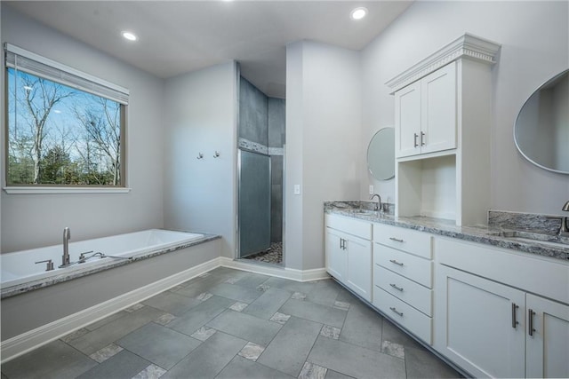 20473 199th St, Tonganoxie, KS 66086 - full bath with a bath, double vanity, baseboards, a stall shower, and recessed lighting