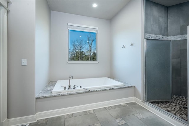 20473 199th St, Tonganoxie, KS 66086 - full bath with a shower stall, a bath, baseboards, and recessed lighting