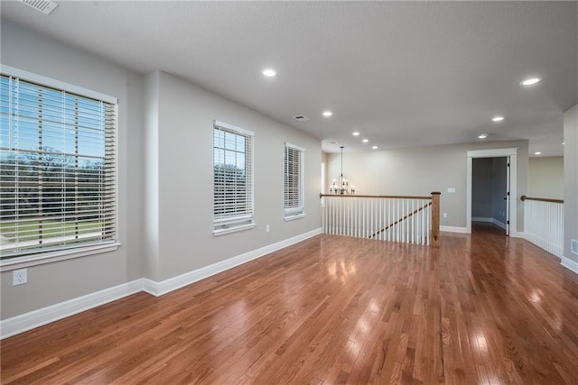 20473 199th St, Tonganoxie, KS 66086 - spare room with a chandelier, wood finished floors, recessed lighting, and baseboards