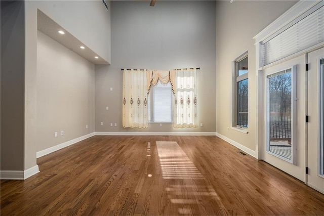 20473 199th St, Tonganoxie, KS 66086 - unfurnished room featuring a towering ceiling, baseboards, wood finished floors, and recessed lighting
