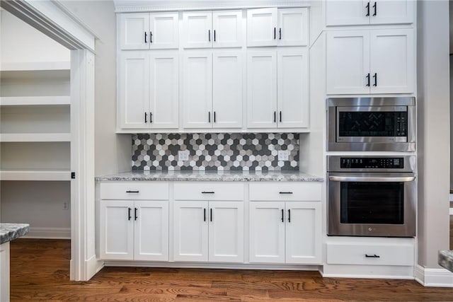 20473 199th St, Tonganoxie, KS 66086 - kitchen featuring appliances with stainless steel finishes, white cabinetry, and tasteful backsplash