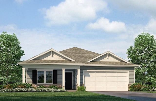 view of front of home with a front yard and a garage