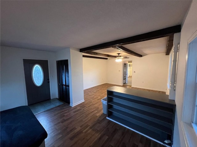 foyer entrance with dark hardwood / wood-style floors, beamed ceiling, and ceiling fan