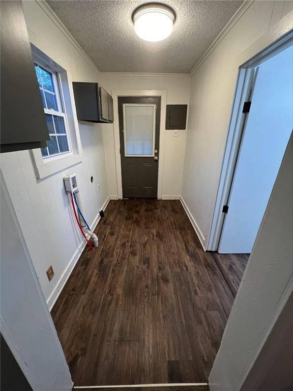 hallway featuring a textured ceiling, crown molding, and dark hardwood / wood-style floors