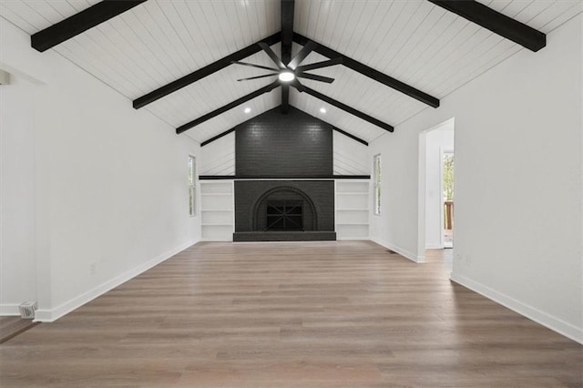 unfurnished living room featuring light hardwood / wood-style floors, wood ceiling, vaulted ceiling with beams, and a fireplace