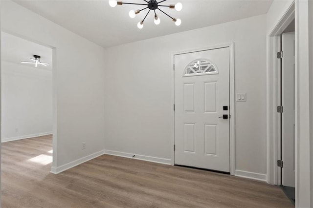 foyer entrance featuring a chandelier and light wood-type flooring