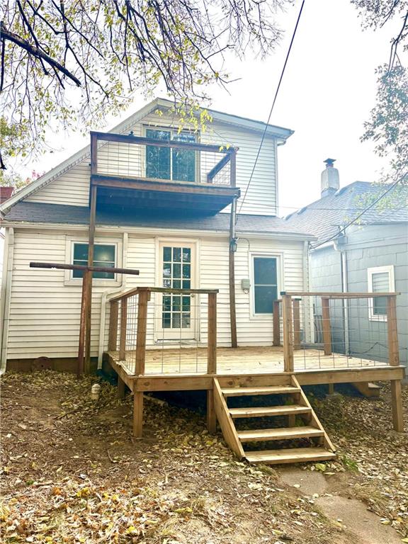 rear view of property with a wooden deck