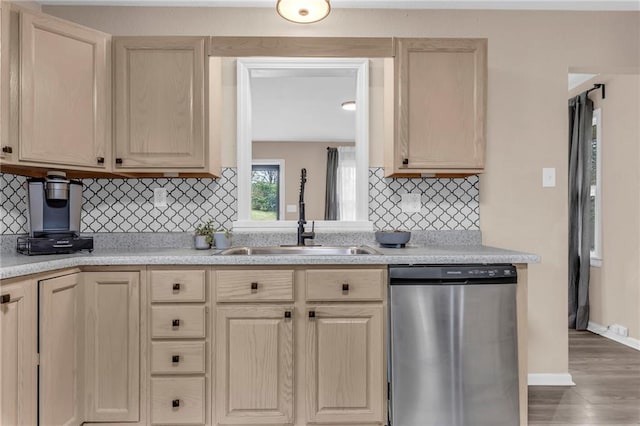 kitchen with tasteful backsplash, dark hardwood / wood-style floors, light brown cabinetry, sink, and stainless steel dishwasher