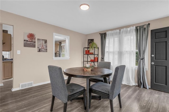 dining space with dark wood-type flooring