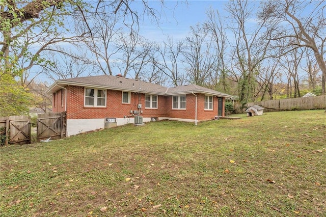 back of property featuring a lawn and cooling unit