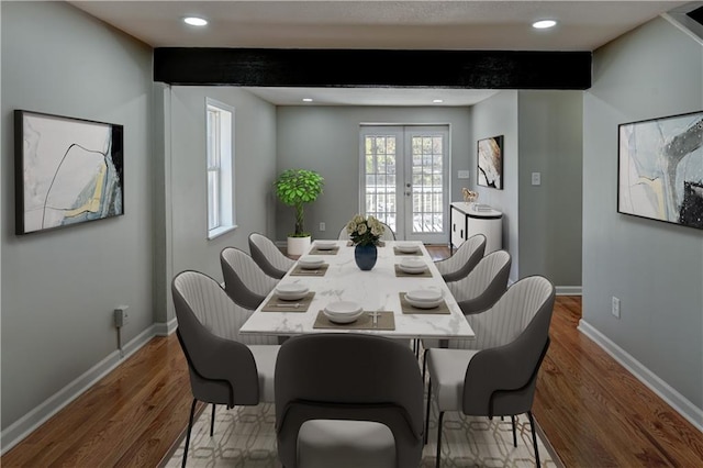 dining area featuring wood-type flooring, french doors, and beamed ceiling