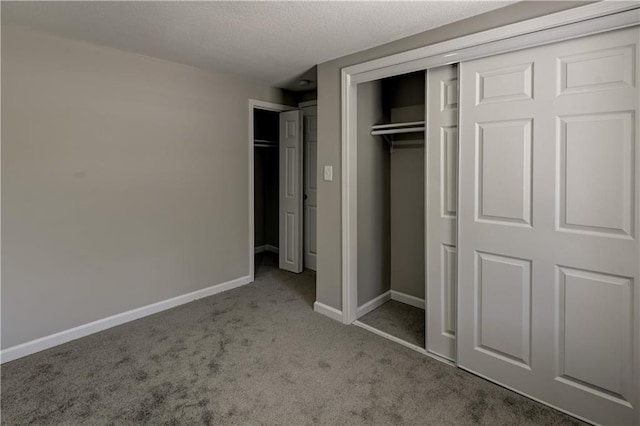 unfurnished bedroom featuring a closet and light carpet