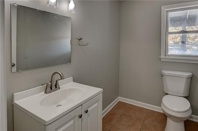 bathroom with vanity, tile patterned floors, plenty of natural light, and toilet