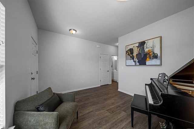 sitting room with dark wood-type flooring