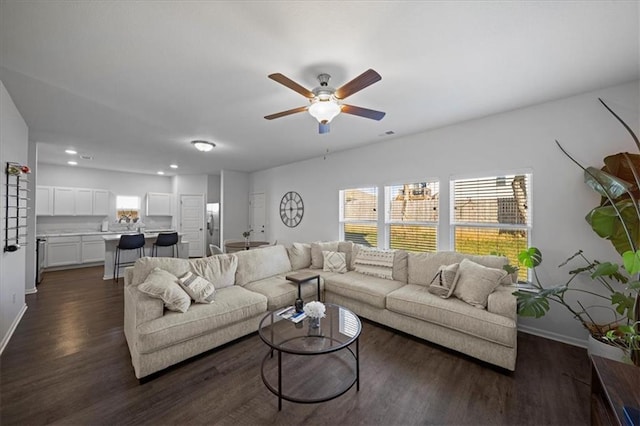 living room with dark wood-type flooring and ceiling fan