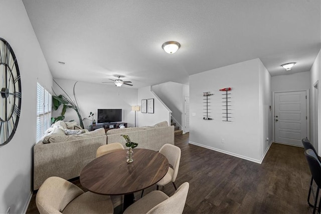 dining space with dark hardwood / wood-style floors and ceiling fan