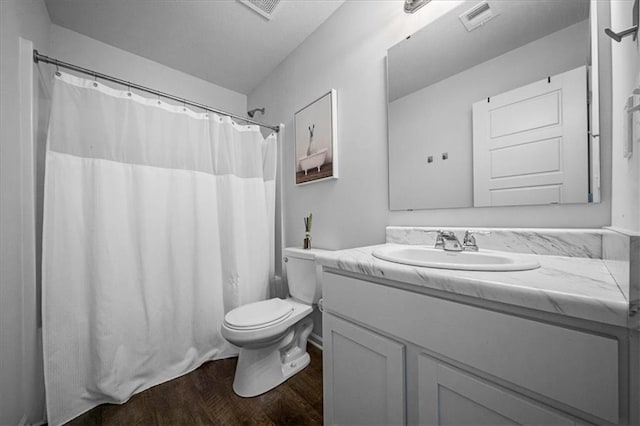 bathroom featuring vanity, toilet, hardwood / wood-style flooring, and a shower with shower curtain