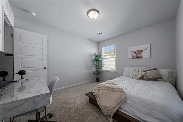 bedroom featuring carpet and a textured ceiling