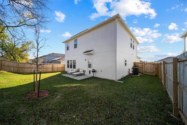 back of house featuring central air condition unit, a patio, and a lawn