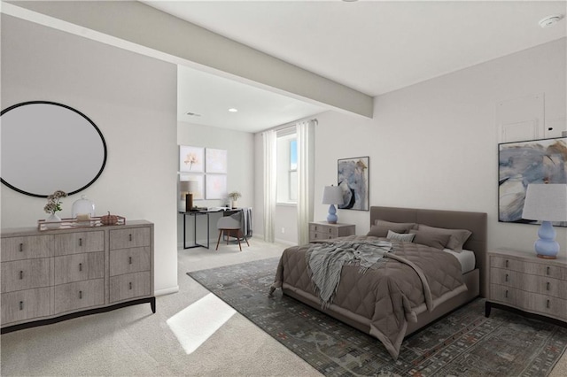 bedroom with beamed ceiling and carpet floors