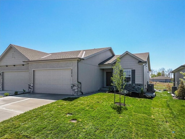 ranch-style home featuring stone siding, concrete driveway, a front yard, and a garage