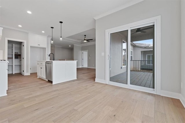 kitchen featuring white cabinets, light wood-style flooring, open floor plan, ceiling fan, and ornamental molding