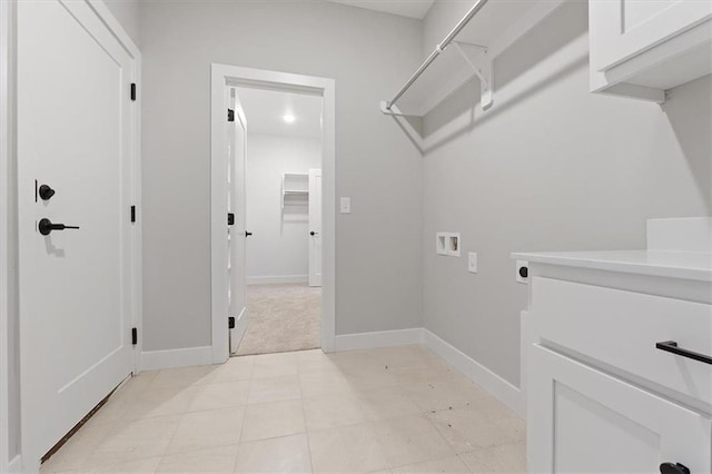 clothes washing area with cabinet space, hookup for a washing machine, baseboards, and hookup for an electric dryer