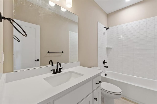 bathroom featuring toilet, vanity, and  shower combination