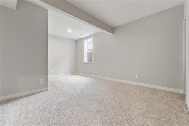 unfurnished room with recessed lighting, baseboards, beam ceiling, and carpet