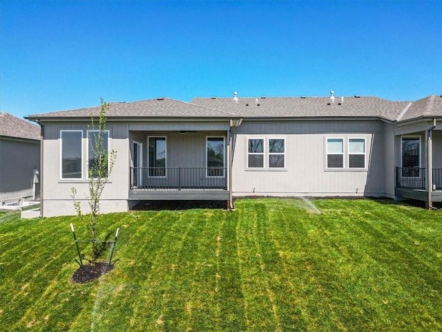 rear view of property with a lawn