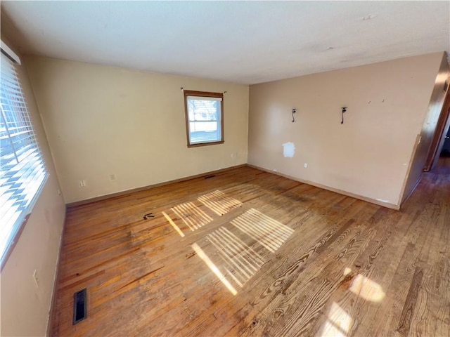 unfurnished room featuring hardwood / wood-style flooring