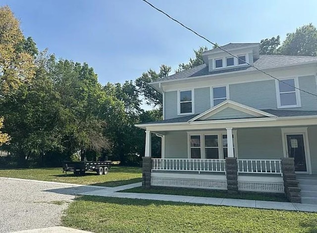 view of front of house featuring a porch and a front lawn