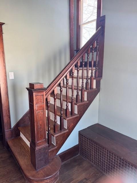 stairs featuring baseboards and wood finished floors